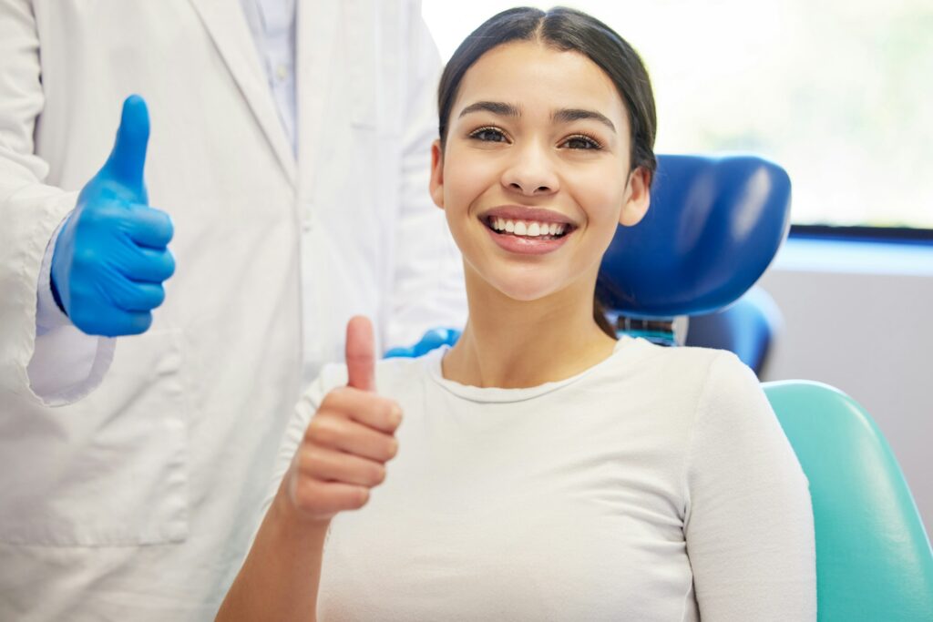 Happy patient giving a thumbs up after receiving quality dental treatment at Wildhorse Dental in Chesterfield, MO.
